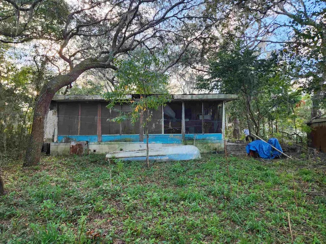 a view of a house with a yard and sitting area