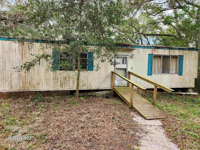a view of a house with wooden fence