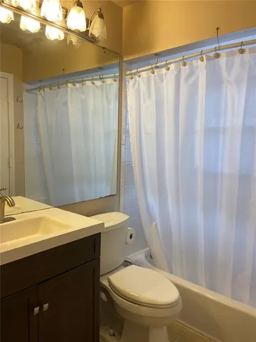 a view of an empty room and wooden floor