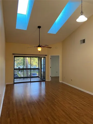 a kitchen with granite countertop white cabinets stainless steel appliances and a sink
