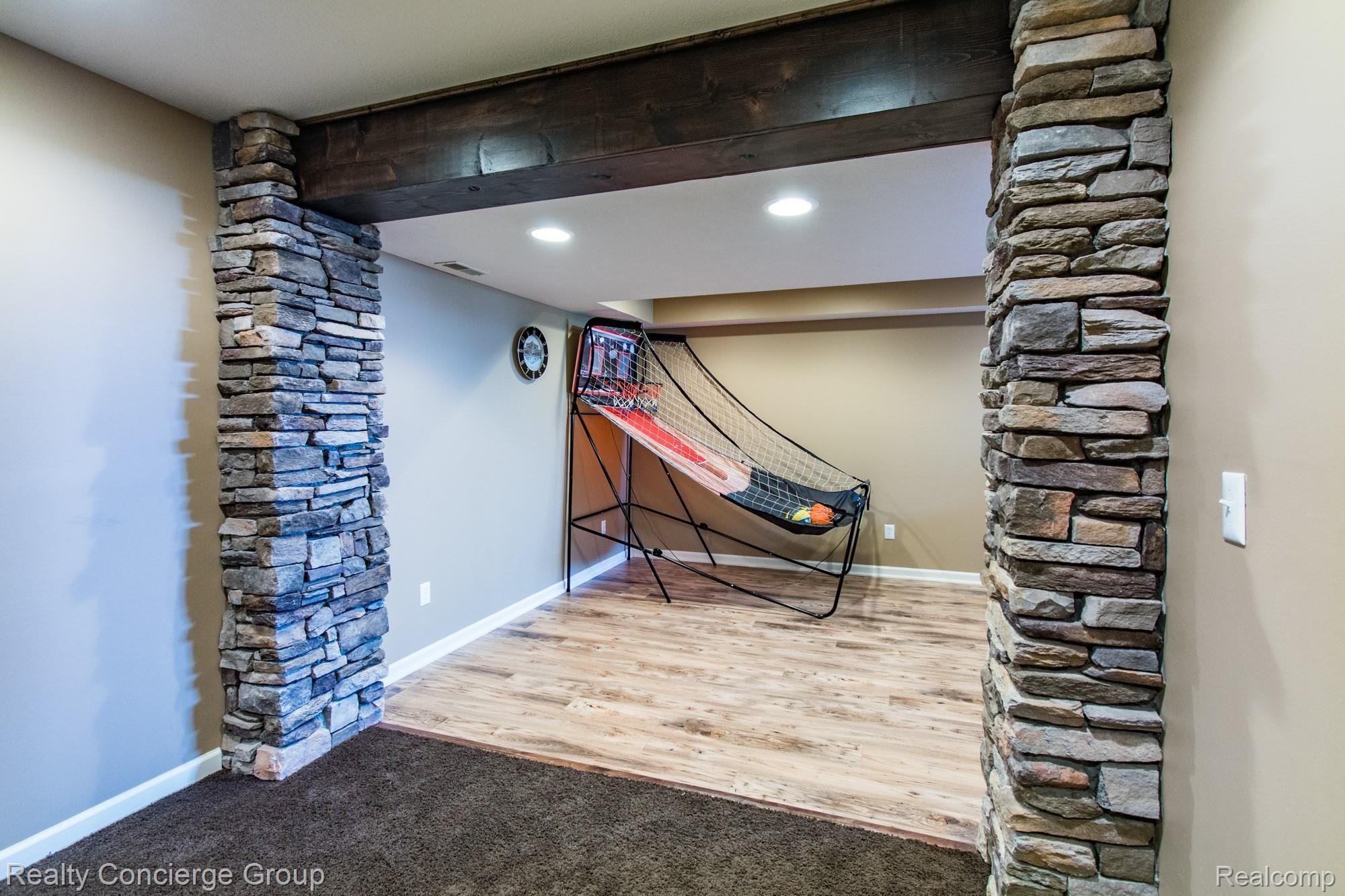 601 North Kane Road Webberville, MI 48892 - Photo 21 of 36 A stone and wood-stained entryway welcome you to the finished basement