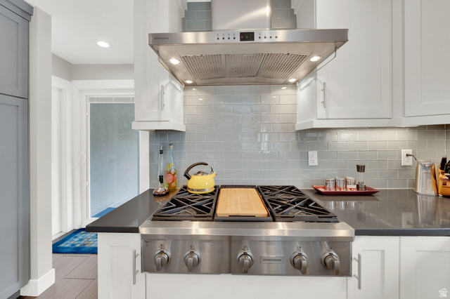 1506 Lakeview Drive Bountiful, UT 84010 - Photo 15 of 58 Kitchen featuring extractor fan, stainless steel gas cooktop, white cabinetry, recessed lighting, and dark quartz countertops