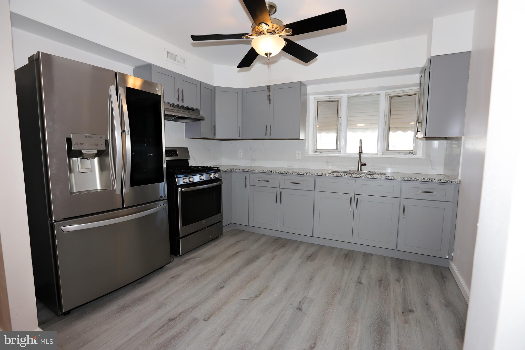 3559 Churchill Lane Philadelphia, PA 19114 - Photo 11 of 30 a kitchen with stainless steel appliances granite countertop a refrigerator a sink and dishwasher