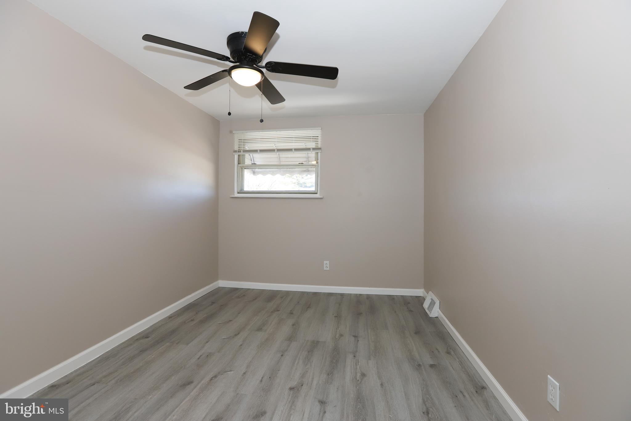 3559 Churchill Lane Philadelphia, PA 19114 - Photo 20 of 30 a view of an empty room with wooden floor and a window