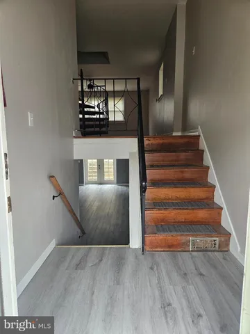 a view of entryway and hall with wooden floor