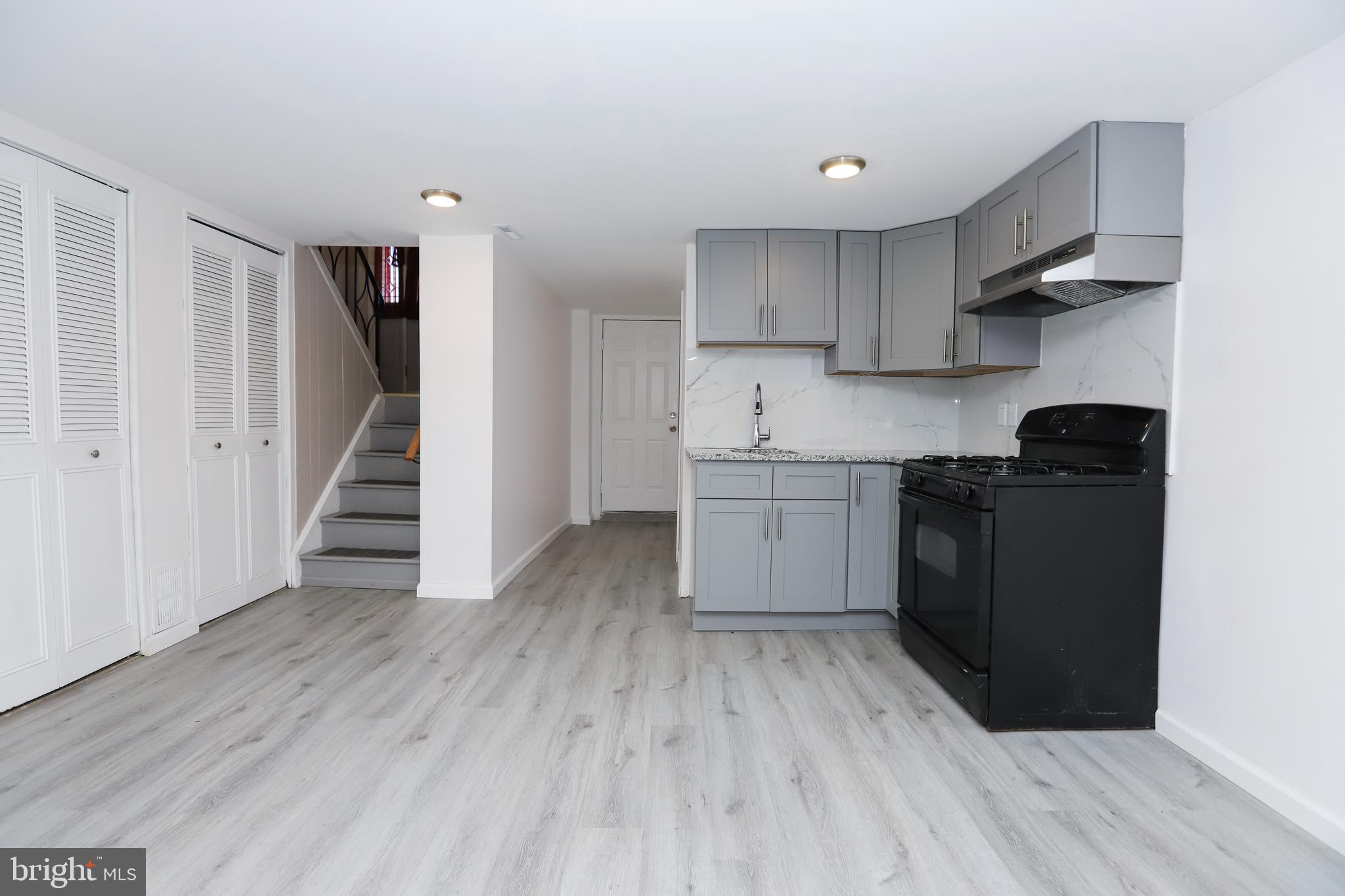 3559 Churchill Lane Philadelphia, PA 19114 - Photo 24 of 30 a kitchen with wooden floors and black appliances