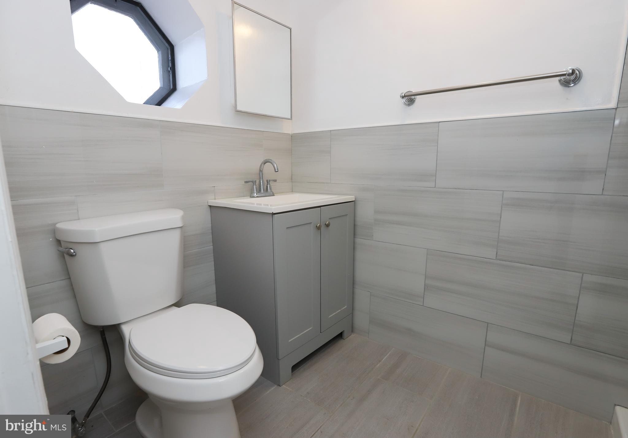 3559 Churchill Lane Philadelphia, PA 19114 - Photo 25 of 30 a bathroom with a sink a toilet and mirror