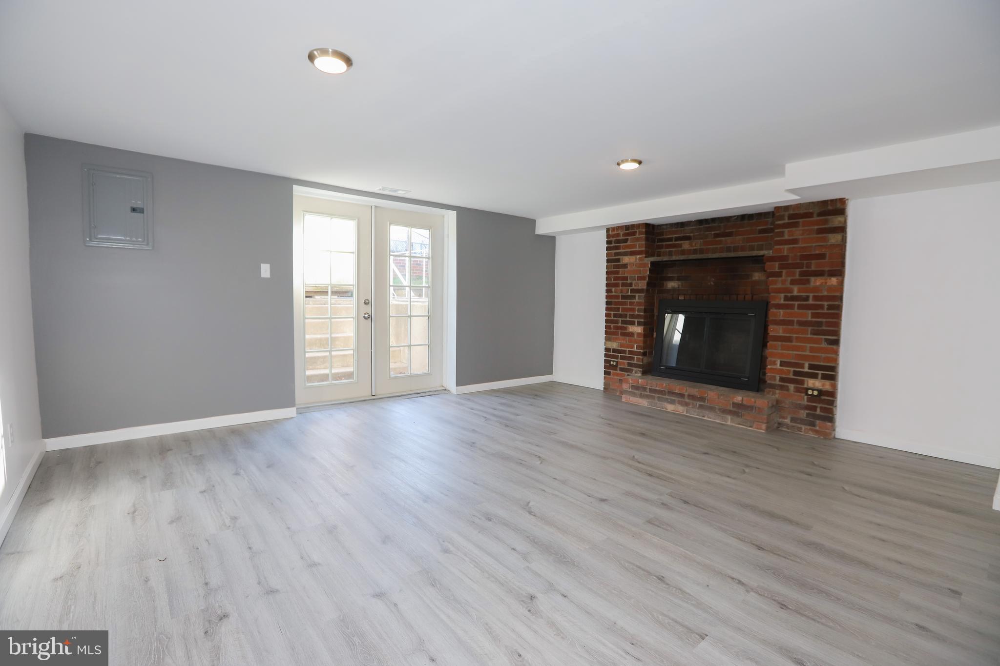 3559 Churchill Lane Philadelphia, PA 19114 - Photo 27 of 30 an empty room with wooden floor and fireplace