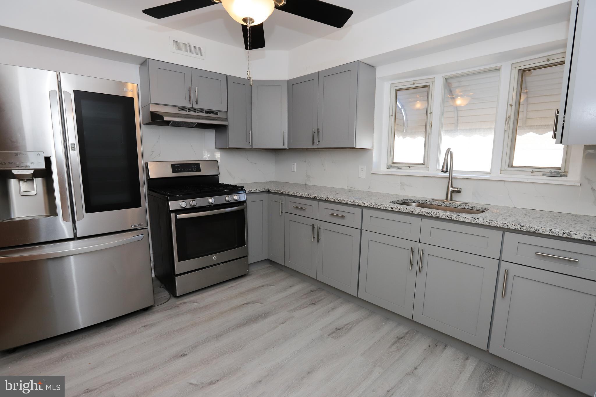 3559 Churchill Lane Philadelphia, PA 19114 - Photo 10 of 30 a kitchen with kitchen island granite countertop a sink stainless steel appliances and counter space