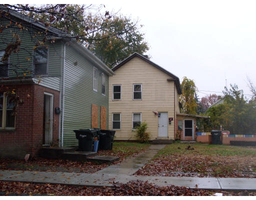 a view of a small house with a yard