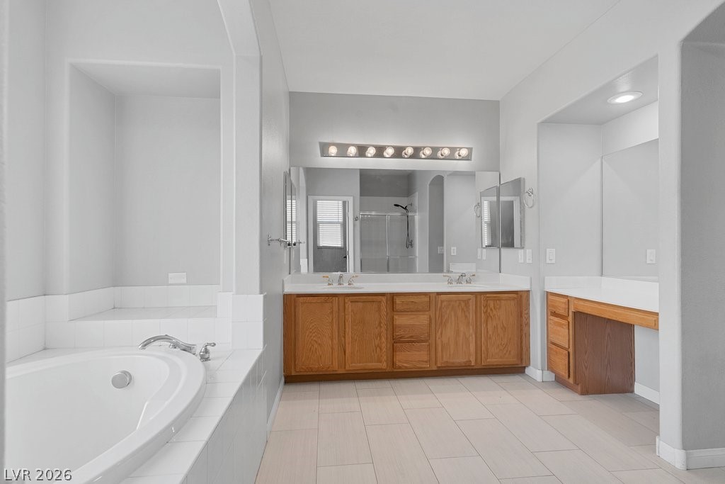 10336 Hawk Ravine Street Las Vegas, NV 89178 - Photo 31 of 59 This primary bathroom features a double vanity, a built-in soaking tub, and a separate Makeup Vanity.