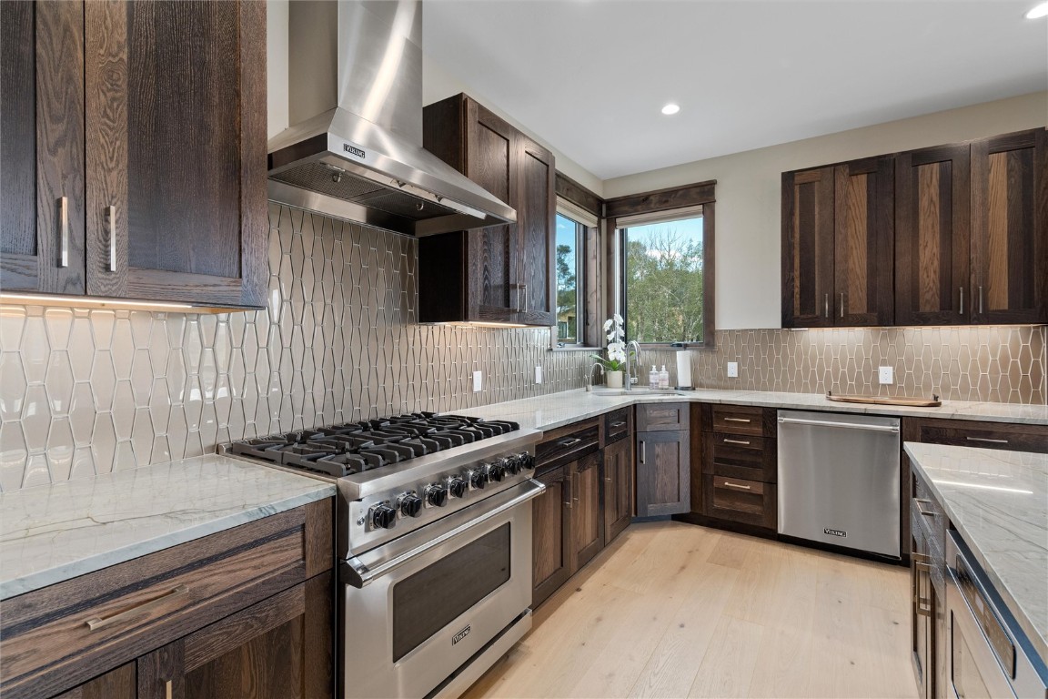 344 Angler Mountain Ranch Road Silverthorne, CO 80498 - Photo 15 of 32 a kitchen with stainless steel appliances granite countertop a stove a sink and a microwave