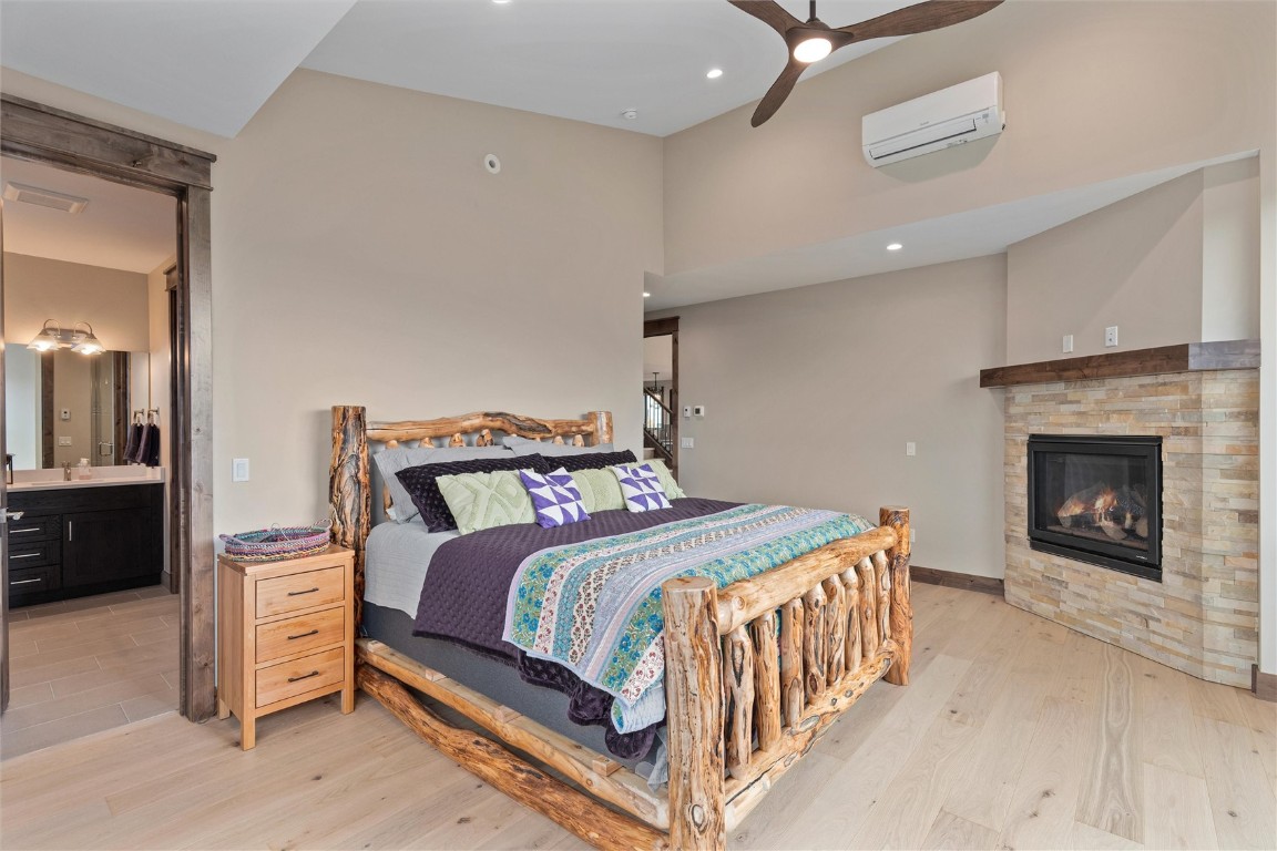 344 Angler Mountain Ranch Road Silverthorne, CO 80498 - Photo 16 of 32 a bedroom with a bed and a fireplace