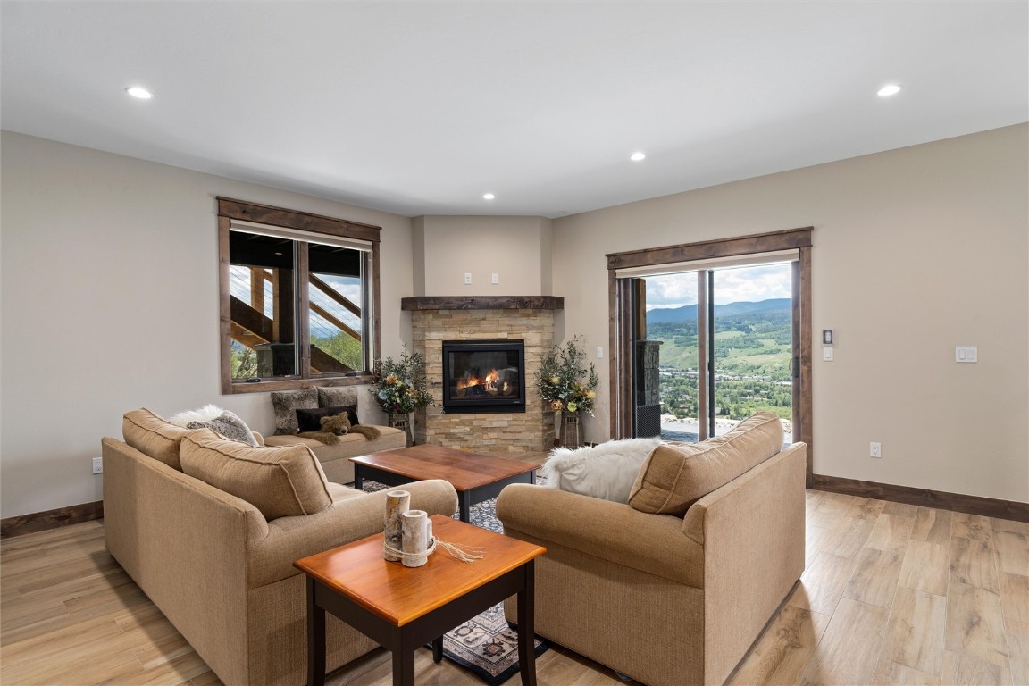 344 Angler Mountain Ranch Road Silverthorne, CO 80498 - Photo 23 of 32 a living room with furniture and a fireplace