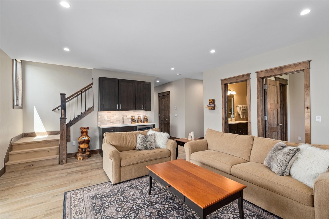 344 Angler Mountain Ranch Road Silverthorne, CO 80498 - Photo 25 of 32 a living room with a couch and a coffee table with wooden floor