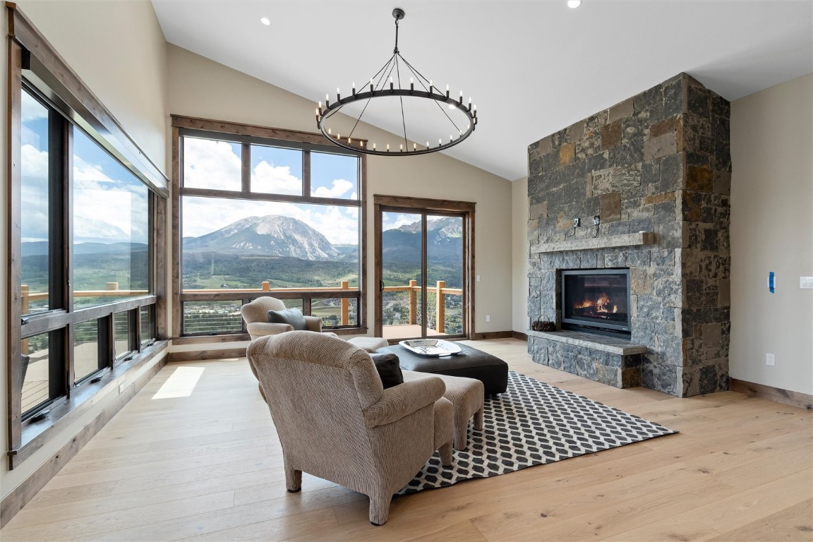 344 Angler Mountain Ranch Road Silverthorne, CO 80498 - Photo 10 of 32 a living room with furniture a large window and a fireplace