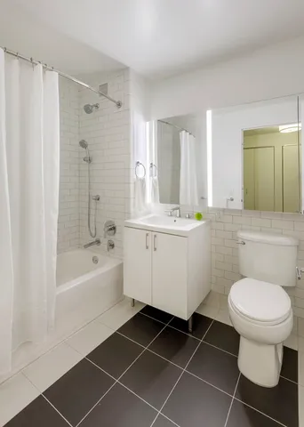 a bedroom with a bed and a wall painting