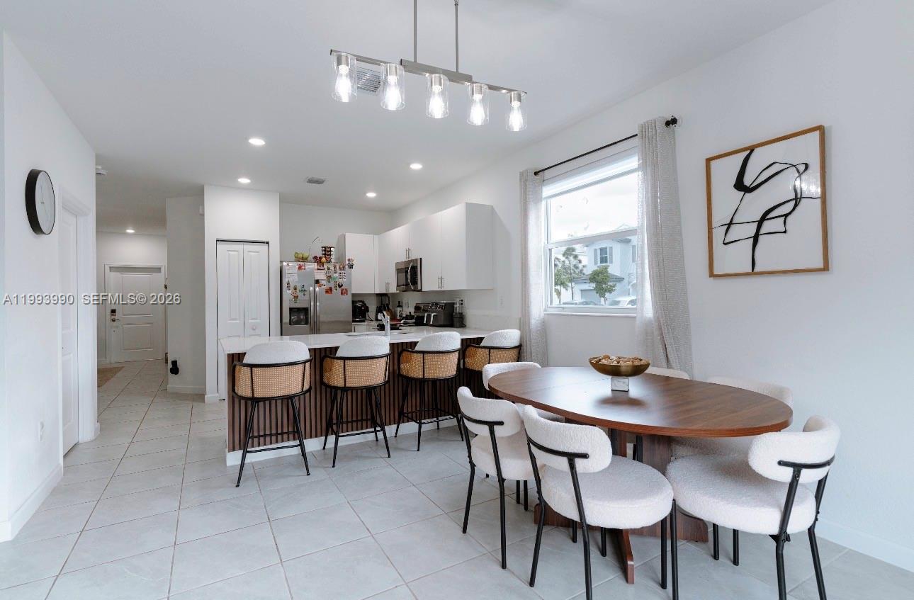 16222 Southwest 290th Terrace, Unit 16222 Homestead, FL 33033 - Photo 15 of 38 a view of a dining room with furniture and window