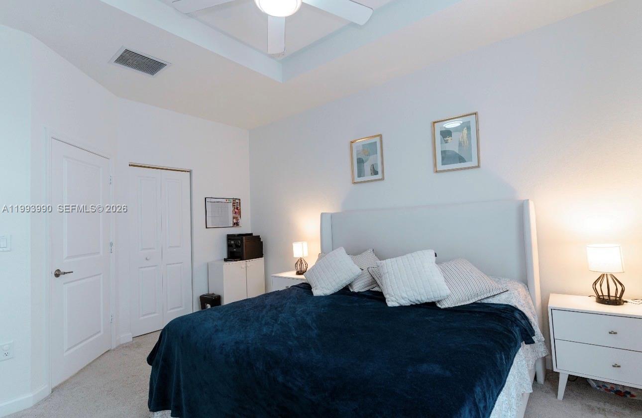 16222 Southwest 290th Terrace, Unit 16222 Homestead, FL 33033 - Photo 17 of 38 a bedroom with a bed and painting on the wall