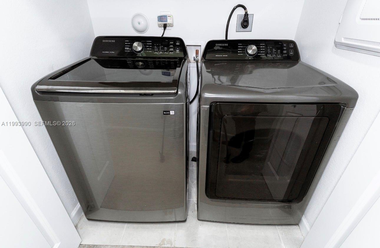 16222 Southwest 290th Terrace, Unit 16222 Homestead, FL 33033 - Photo 22 of 38 a close view of a stove a microwave and a sink
