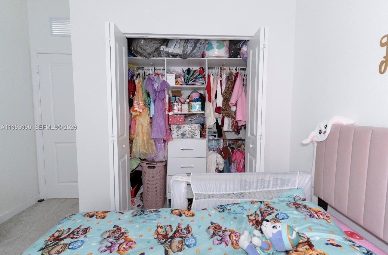 16222 Southwest 290th Terrace, Unit 16222 Homestead, FL 33033 - Photo 28 of 38 a view of bedroom with baby crib