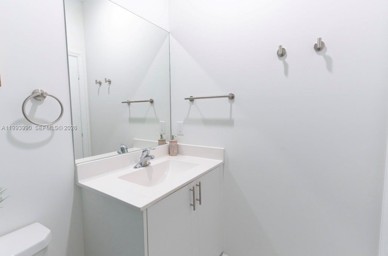 16222 Southwest 290th Terrace, Unit 16222 Homestead, FL 33033 - Photo 29 of 38 a bathroom with a sink and a mirror