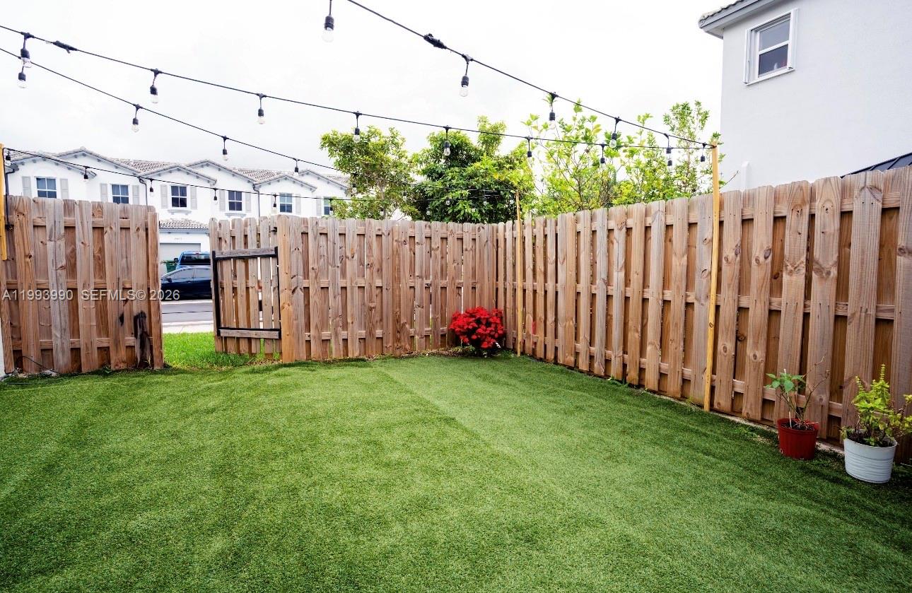 16222 Southwest 290th Terrace, Unit 16222 Homestead, FL 33033 - Photo 31 of 38 a view of a backyard with wooden fence