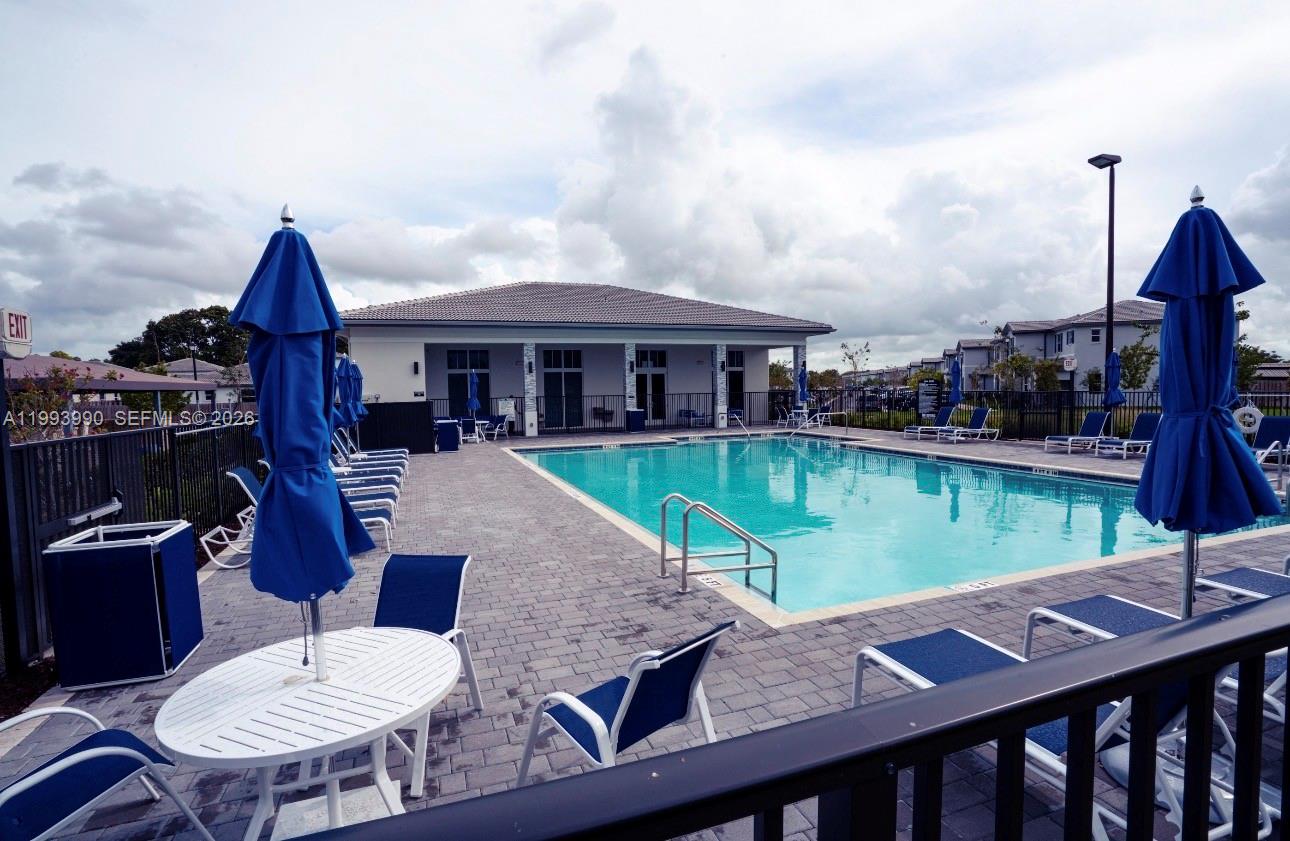 16222 Southwest 290th Terrace, Unit 16222 Homestead, FL 33033 - Photo 35 of 38 a view of a patio with swimming pool