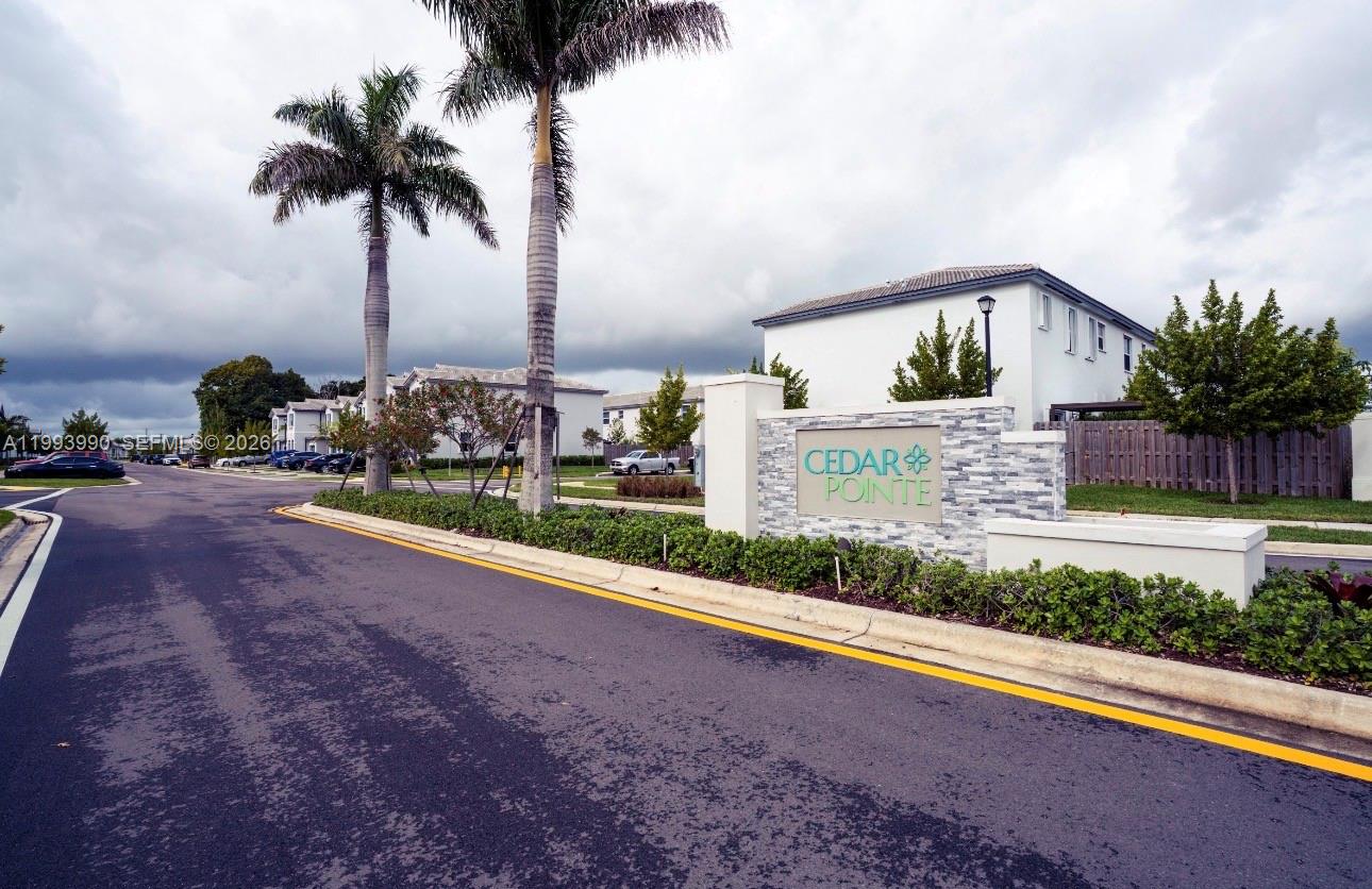 16222 Southwest 290th Terrace, Unit 16222 Homestead, FL 33033 - Photo 37 of 38 a front view of house with yard and trees