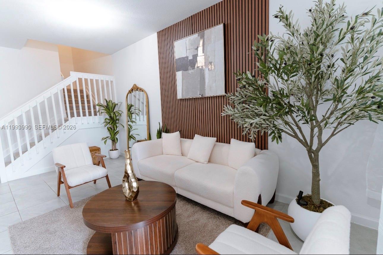 16222 Southwest 290th Terrace, Unit 16222 Homestead, FL 33033 - Photo 6 of 38 a living room with furniture and a potted plant