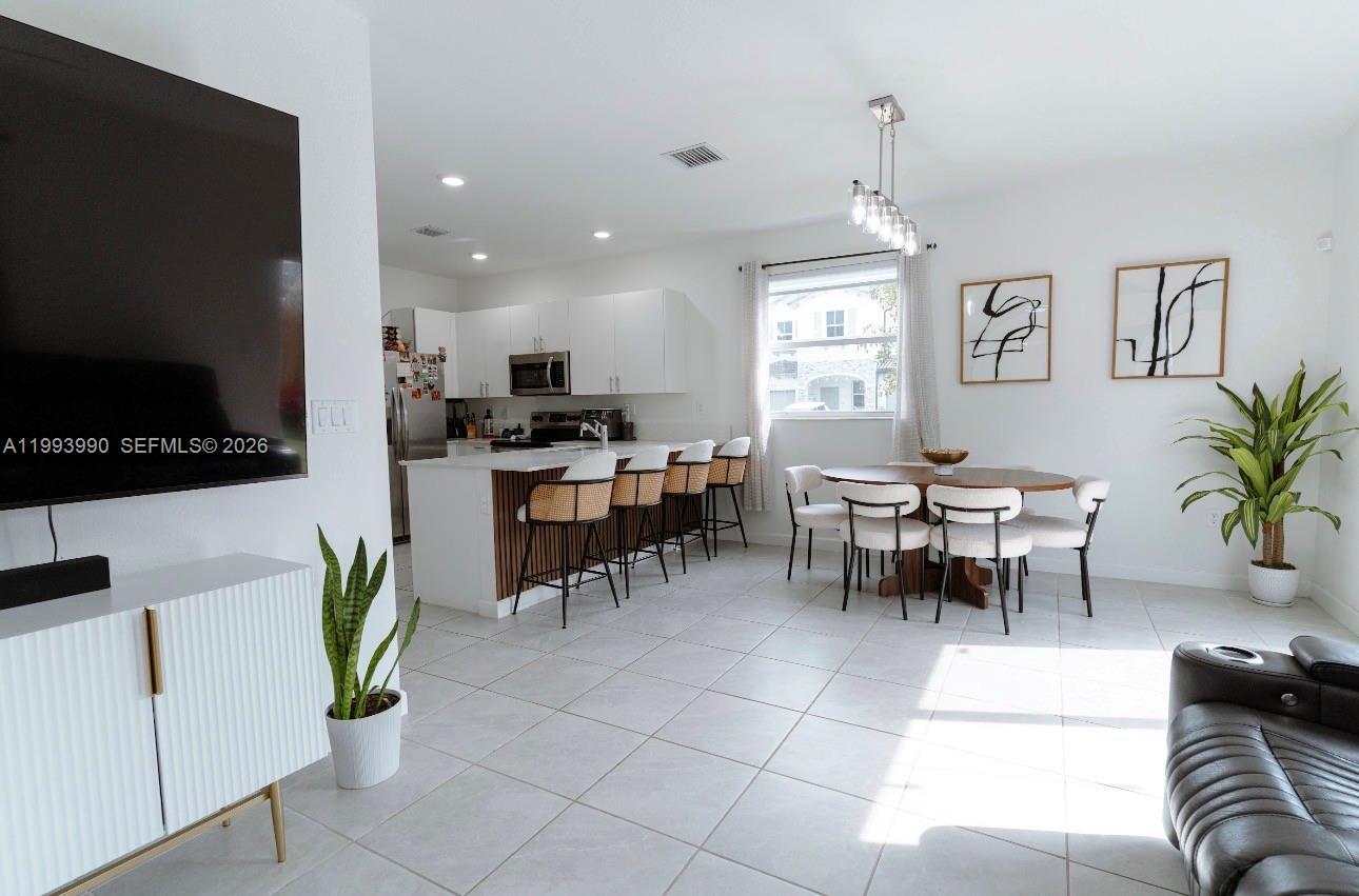16222 Southwest 290th Terrace, Unit 16222 Homestead, FL 33033 - Photo 10 of 38 a view of a dining room with furniture window and wooden floor