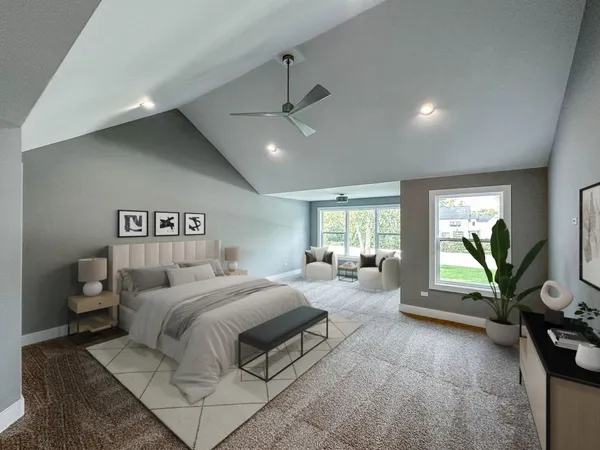 a spacious bedroom with a bed a couch and a flat screen tv