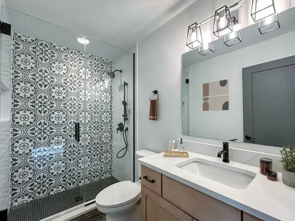 a bathroom with a sink toilet and shower