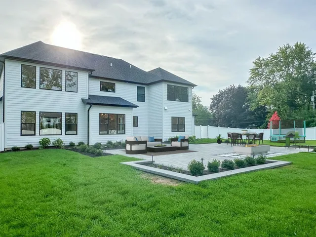 a view of a house with a yard and sitting area