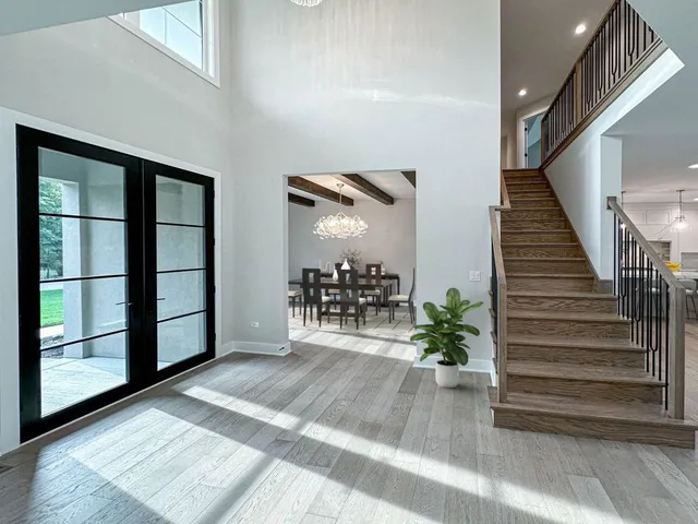 a view of entryway and hall with wooden floor