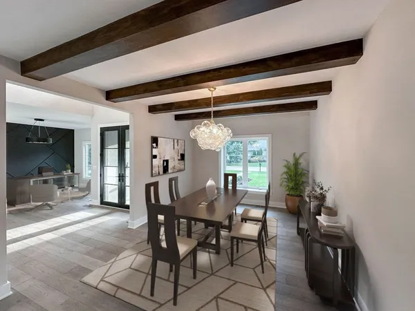 a view of a dining room with furniture and chandelier
