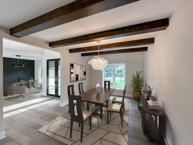 a view of a dining room with furniture and chandelier