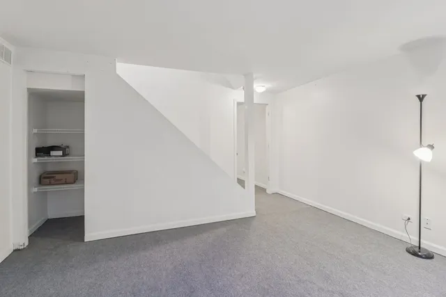 a view of an empty room with a kitchen