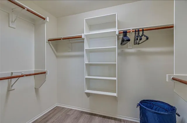 a view of walk in closet with empty racks