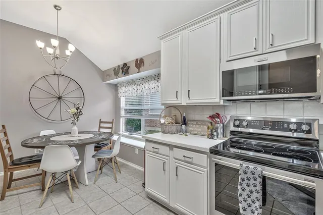 a kitchen with a sink cabinets and window