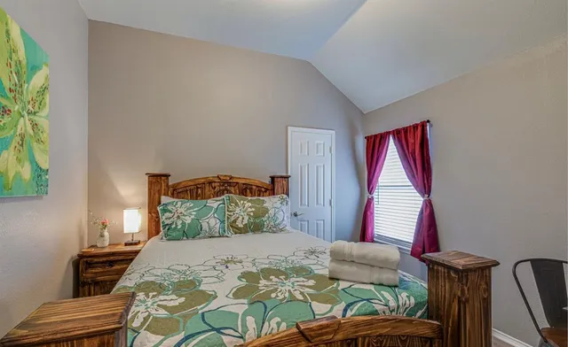 a bedroom with a bed and a window