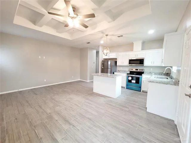 a view of kitchen with sink microwave and stove