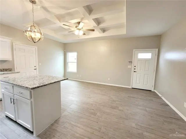 a view of a kitchen and a chandelier wooden floor and chandelier
