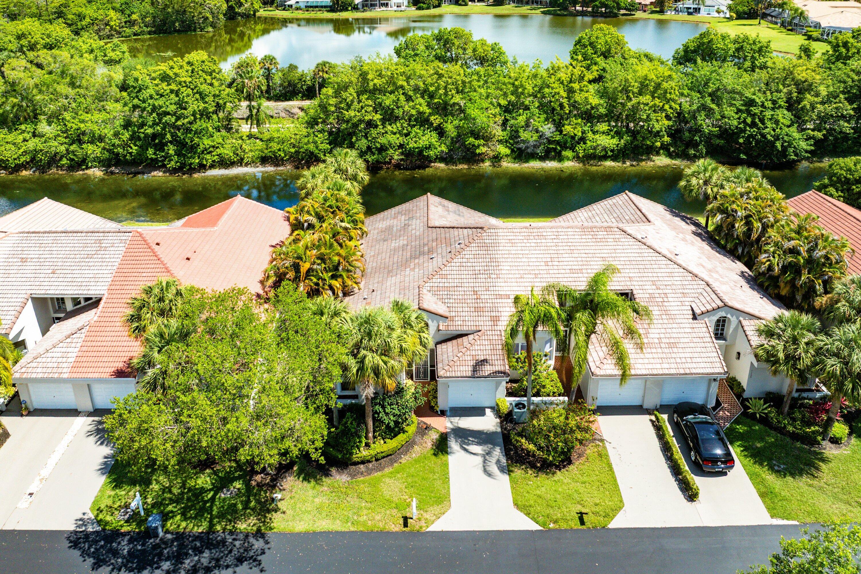 11163 180th Court South Boca Raton, FL 33498 - Photo 6 of 22 an aerial view of a house with a garden and lake view