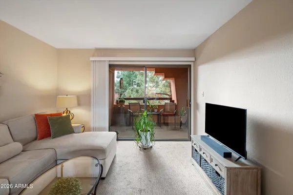 a kitchen with a appliances a window and a dining table