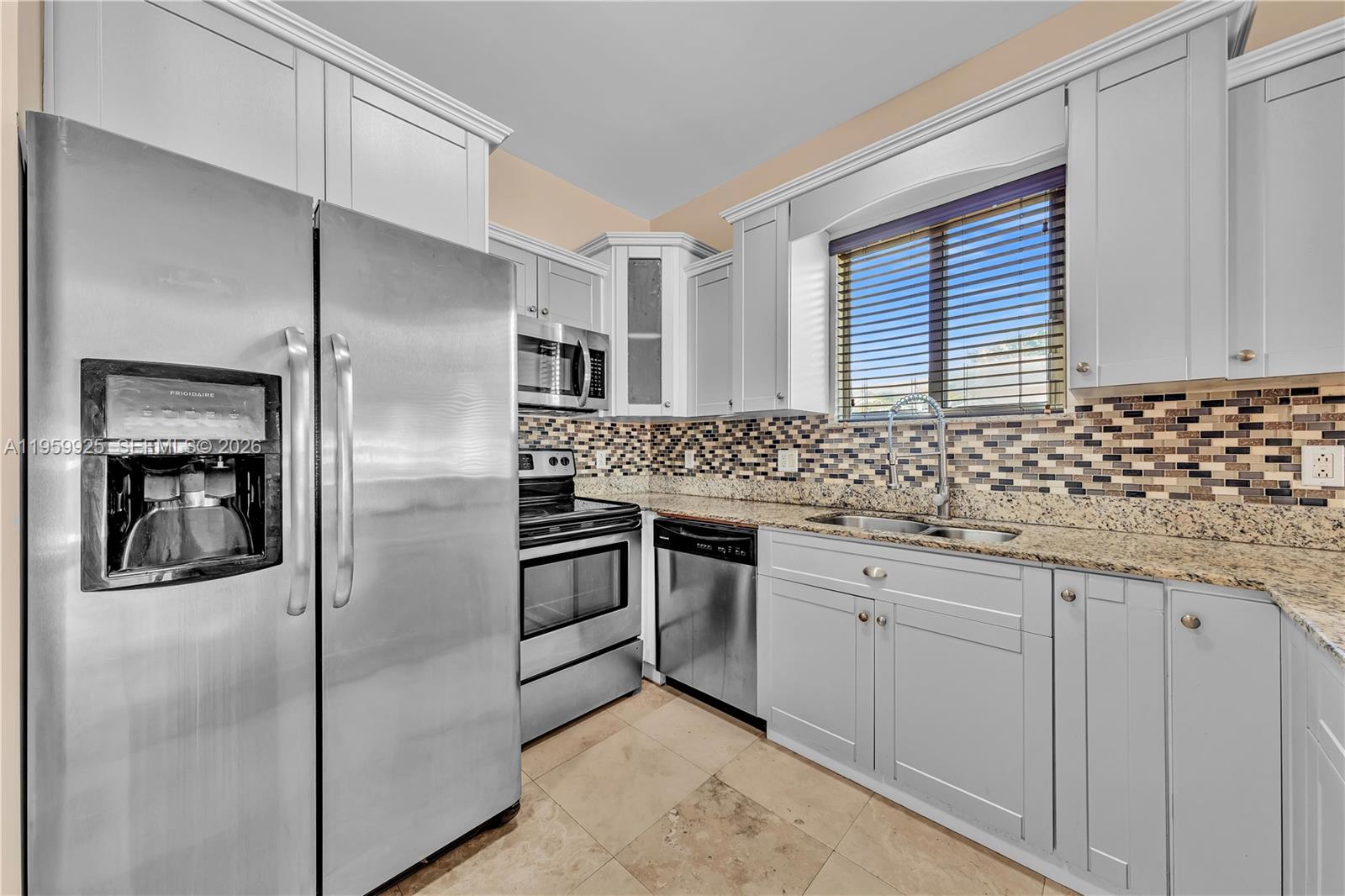 4025 Southwest 10th Street Miami, FL 33134 - Photo 13 of 41 a kitchen with granite countertop a sink stove and refrigerator