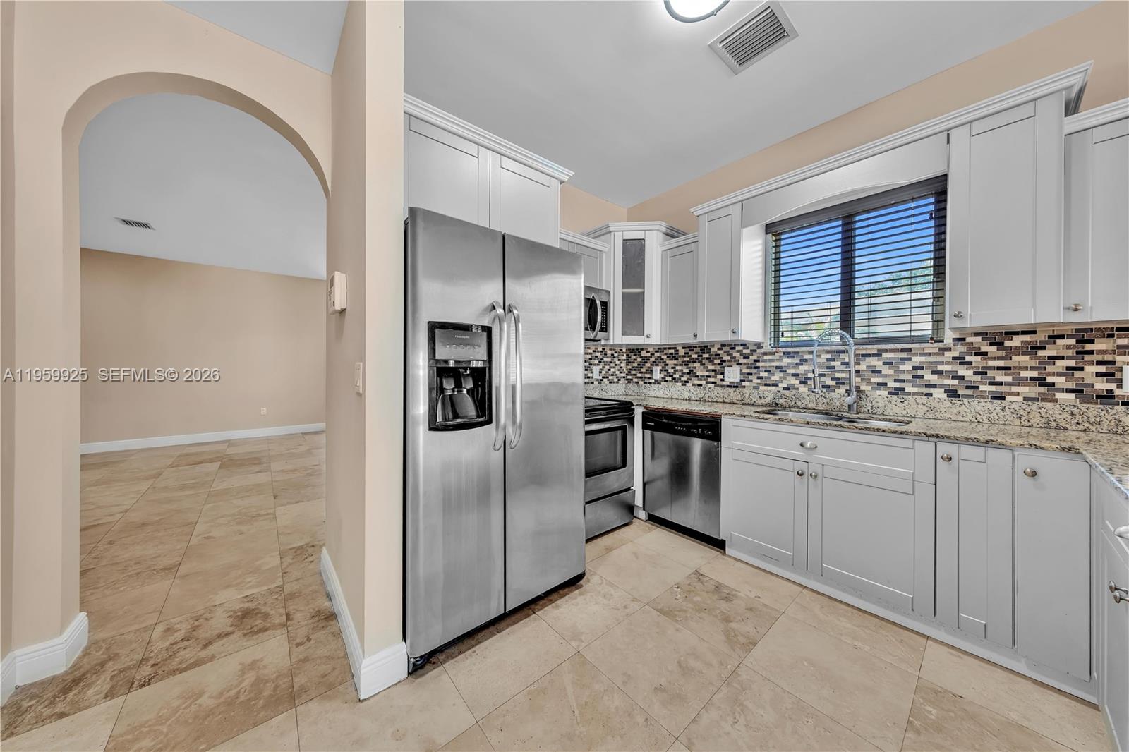 4025 Southwest 10th Street Miami, FL 33134 - Photo 14 of 41 a kitchen with stainless steel appliances granite countertop a refrigerator and a sink