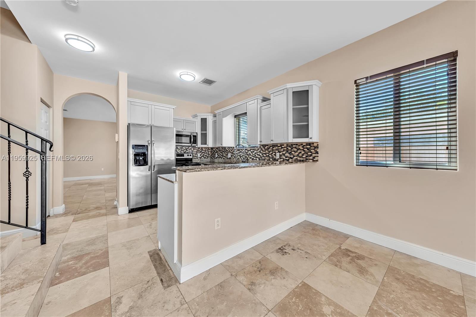 4025 Southwest 10th Street Miami, FL 33134 - Photo 16 of 41 a kitchen with stainless steel appliances granite countertop a refrigerator and a stove top oven