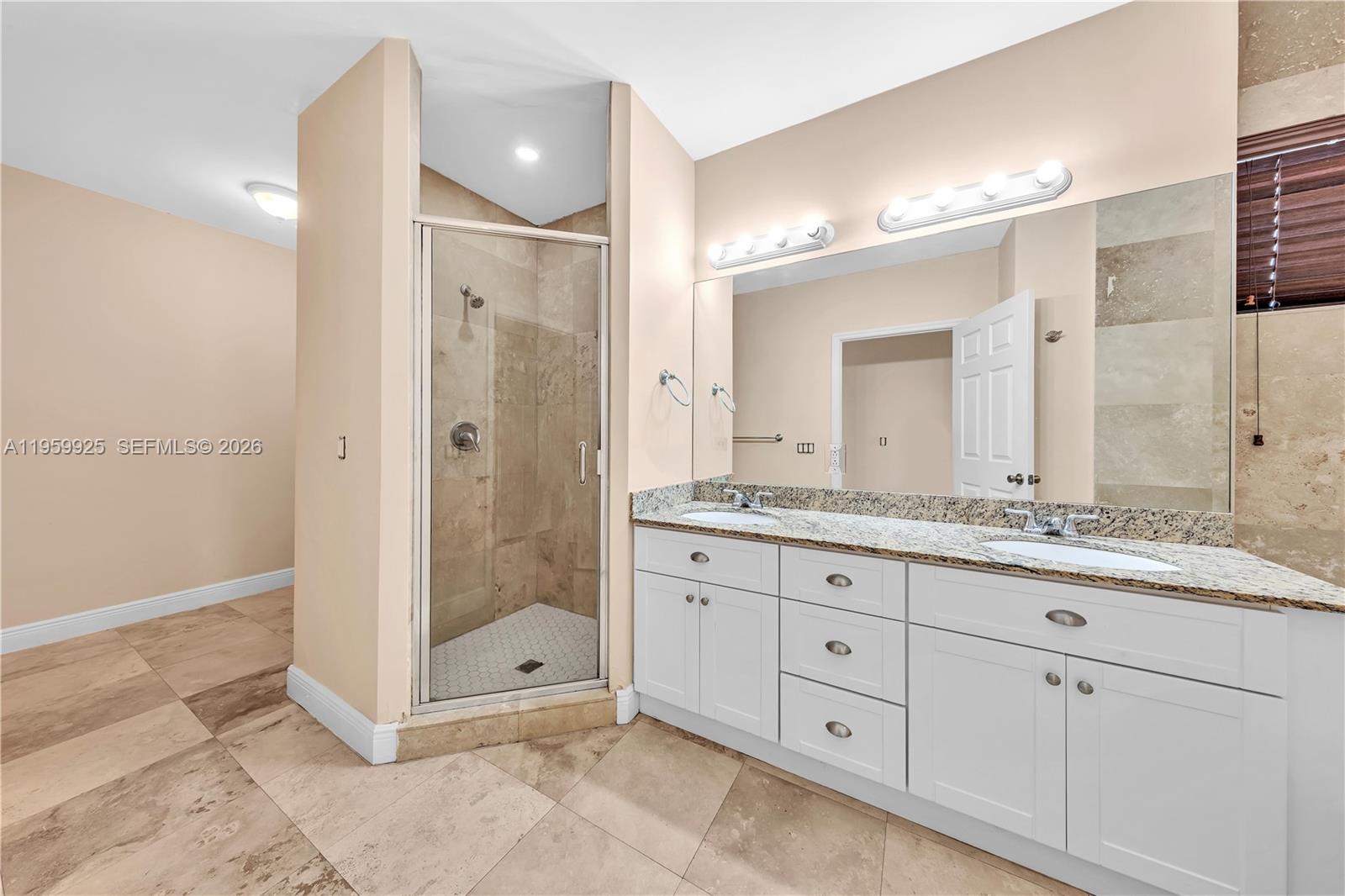 4025 Southwest 10th Street Miami, FL 33134 - Photo 24 of 41 a bathroom with a granite countertop sink mirror and shower