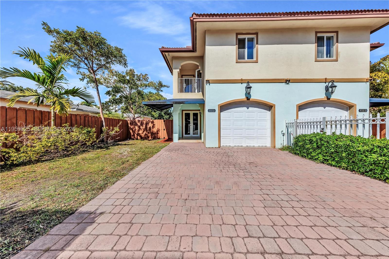 4025 Southwest 10th Street Miami, FL 33134 - Photo 3 of 41 a front view of a house with a yard and a garage
